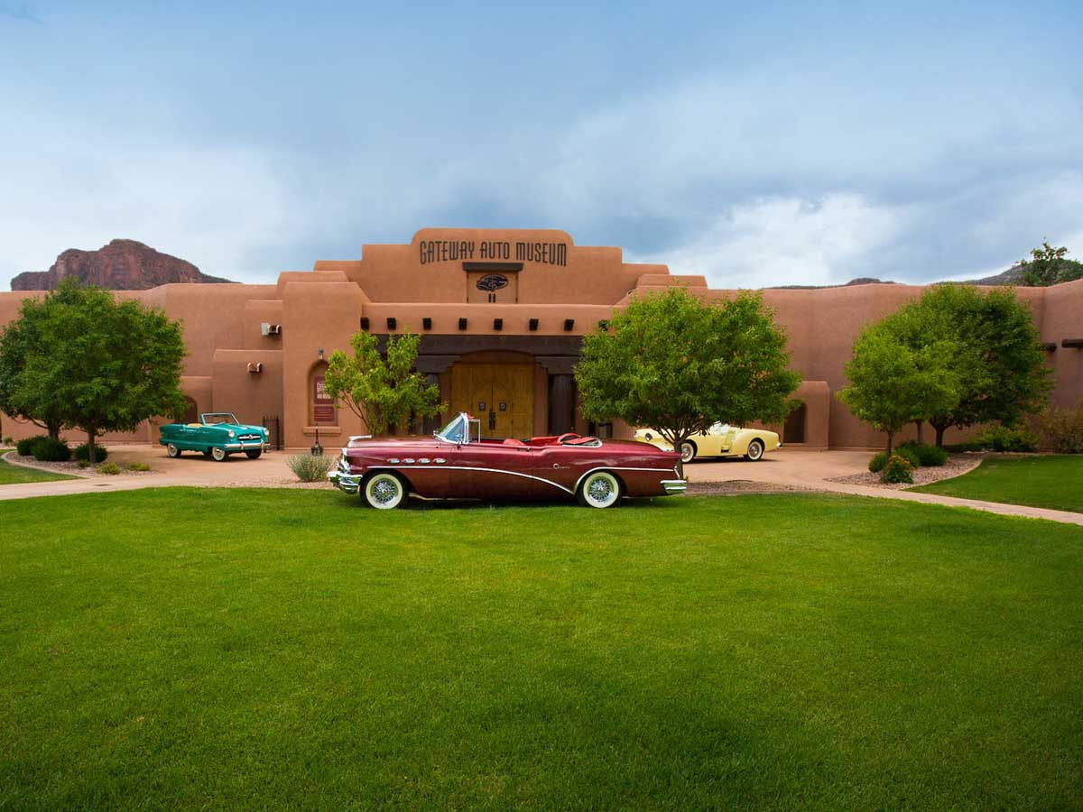 Antique car on lawn in front of Gateway Auto Museum