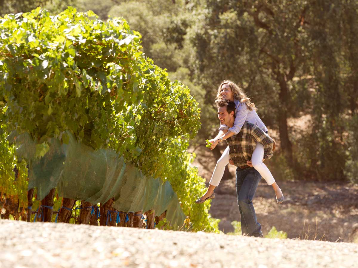 Couple piggyback riding in the outdoors