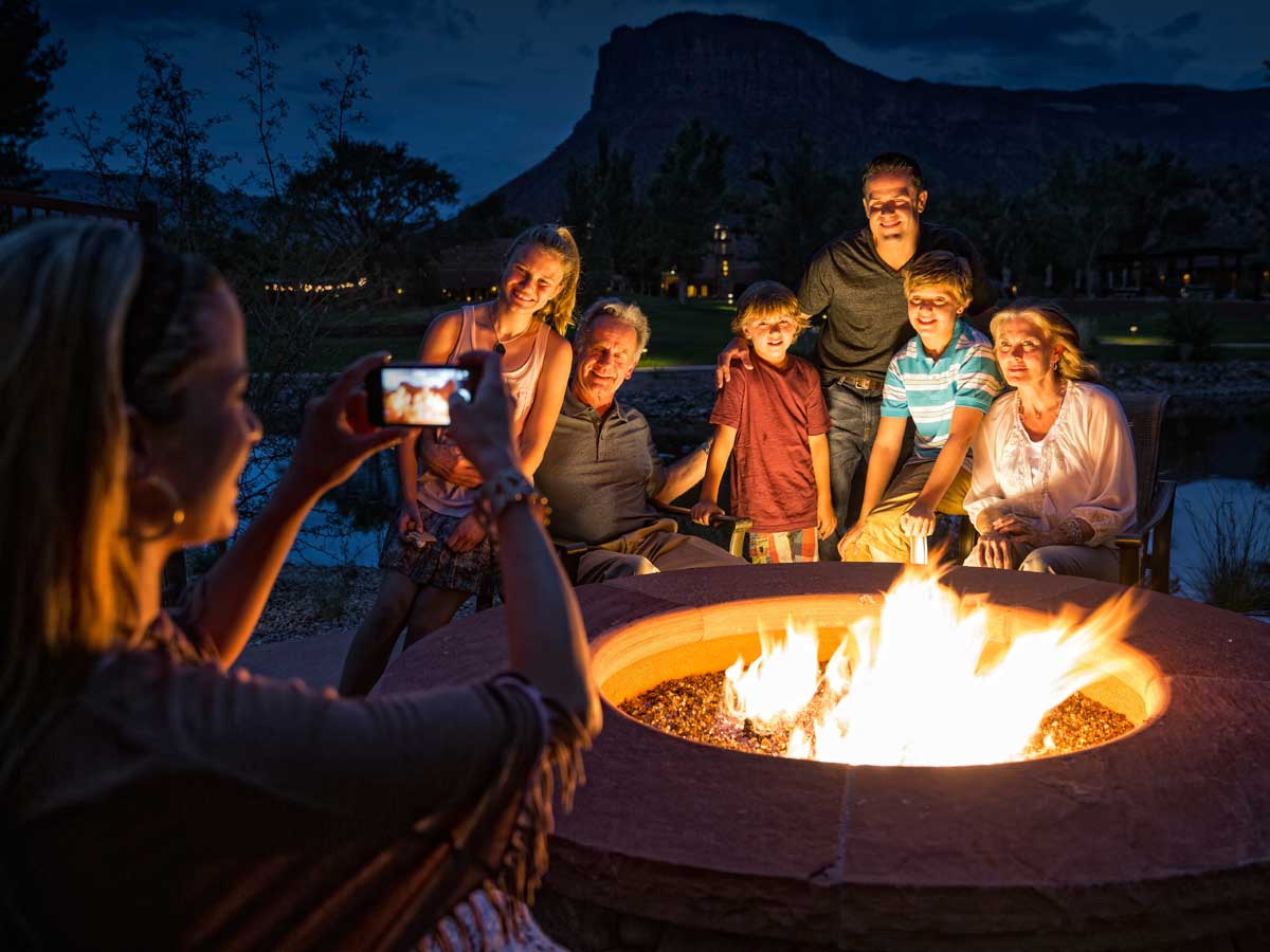 Family photo by fire at Gateway Canyons Resort