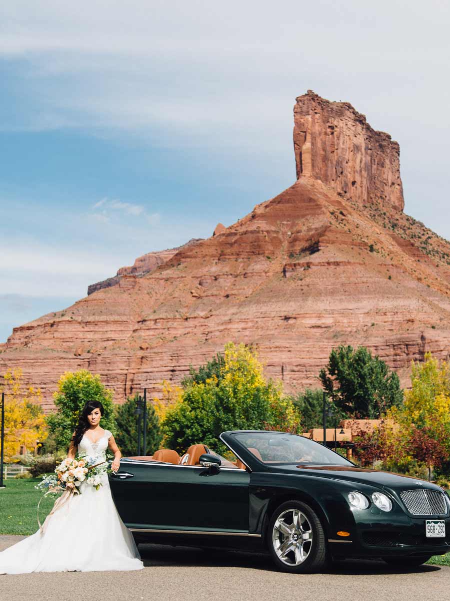 Bride In Front Of Sports Car At Gateway.